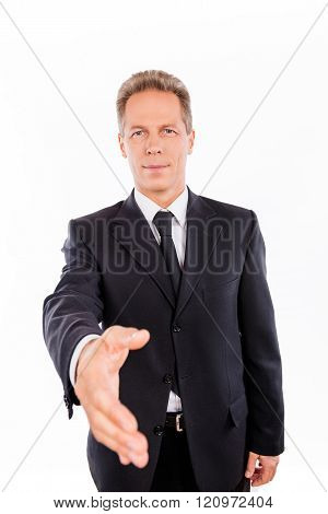 Portrait Of Aged Businessman With Outstreched Hand On The White Background