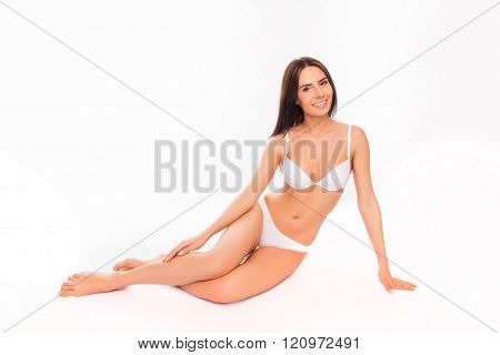 Sexy Young Brunette In Underlinen Sitting On White Background