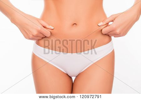 Close Up Portrait Of Fit Woman Checking Fat On Her Belly