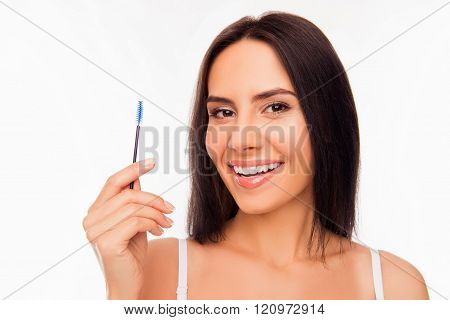 Portrait Of Chherful Young Woman Holding Brush For Mascara