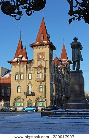The building is in the Gothic style. Conservatory in Saratov. Monument Chernyshesky against the background of the historic building.