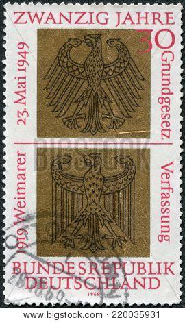 GERMANY - CIRCA 1969: A stamp printed in Germany, dedicated to 20th anniversary of the German Basic Law and the 50th anniversary of the proclamation of the Weimar Constitution, shows a Heraldic Eagles of Federal and Weimar Republics, circa 1969
