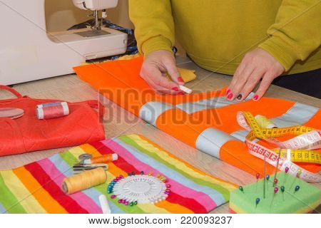Clothes designer at work in her office. Female fashion designer working at studio. Garment industry, tailoring concept