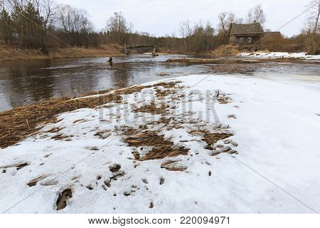 Old collapsed watermills near the river in the early spring.