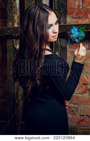 portrait of beautiful brunette woman holding in her hands bouquet of wild flowers. Enjoying sun. Happiness and love concept. Beautiful flowers. Romantic mood. Sunny day on the nature