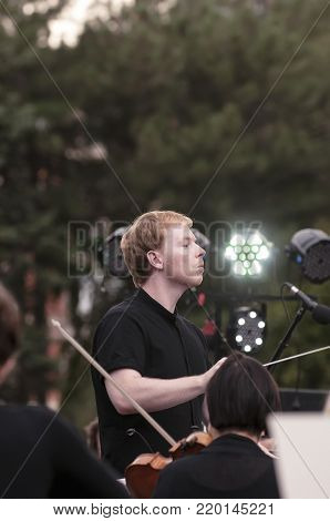 ROSTOV-ON-DON, RUSSIA - 10 SEPTEMBER 2017. Performance of the Rostov Academic Symphony Orchestra on the Public Library site. The conductor of orchestra. Matvienko Dmitry.