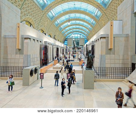 PARIS, FRANCE - SEPTEMBER 12, 2013: People in the Musee d'Orsay. Opened in 1986, the museum houses the largest collection of impressionist and post-impressionist masterpieces in the world