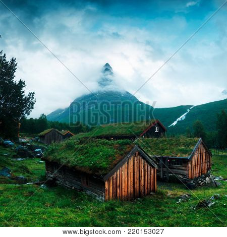 Typical norwegian old wooden houses with grass roofs in Innerdalen - Norway's most beautiful mountain valley, near Innerdalsvatna lake. Norway, Europe