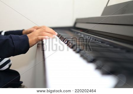 Hands Of Japanese Boy Playing A Piano (second Grade At Elementary School)