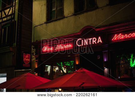 STRASBOURG, FRANCE - DEC 23, 2017: CINTRA neon light Chez Marco traditional French pub serving food and drinks in Strasbourg, France