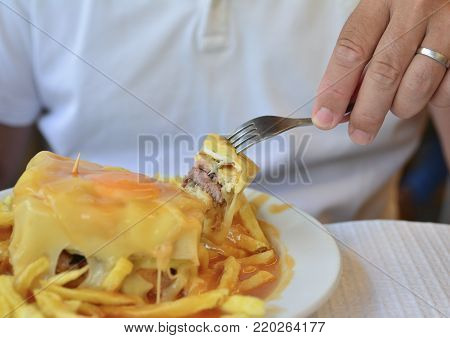 A portuguese sandwich Francesinha served with french fries original dish in Porto, Portugal