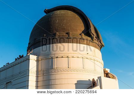 LOS ANGELES, CALIFORNIA - NOVEMBER 19, 2017:  People enjoy the view from atop Griffith Observatory, near the dome housing a Zeiss 12-inch refracting telescope and available for nightly public viewing