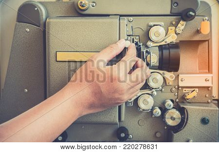 Close Up Of Vintage Classic Mobile 8Mm Or 16Mm Movie Film Projector With Hand And Vintage Color Styl