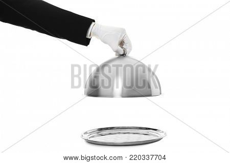 Waiter's hand holding cloche over tray against white background