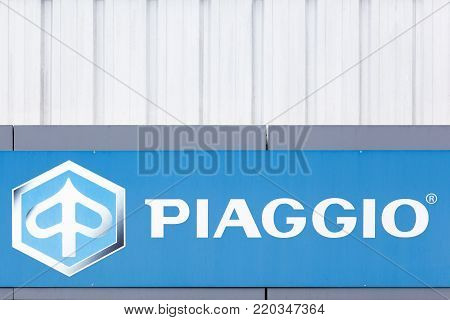 Grenoble, France - June 25, 2017: Piaggio logo on a wall. Piaggio is an Italian motor vehicle manufacturer and distributes two wheeled motor vehicles and compact commercial vehicles