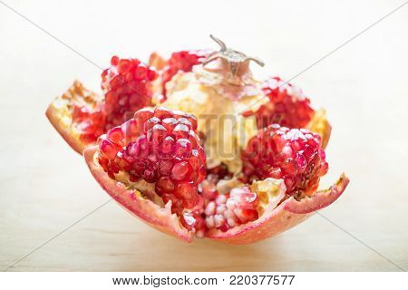 Cleaned pomegranate.  How to Deseed a Pomegranate. Health benefits of Punica granatum. Juicy and raw fruits on a wooden background. Pomegranate, pomegranate seeds, apple, wild grapes