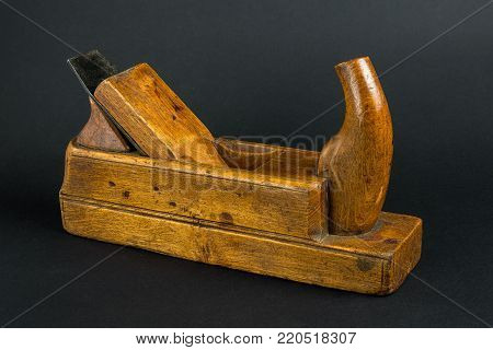 Old carpenter tool wood Plane on a gray background