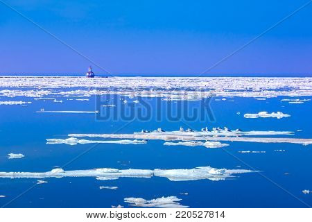 Ice floes and lighthouse along the shores of Prince Edward Island, Canada.
