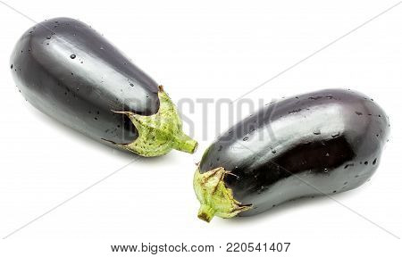 Two whole eggplants (aubergine) with water drops isolated on white background