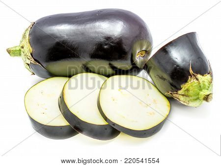 One whole and sliced eggplants (aubergine), round slices, isolated on white background