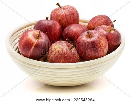 Gala apples in rattan bowl isolated on white background