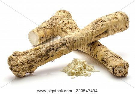 Two whole, one half and freshly grated mash of horseradish root, isolated on white background