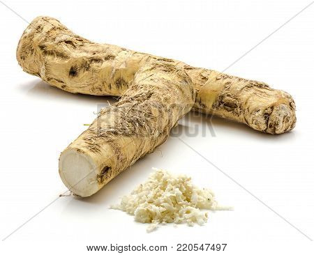 One whole, one half and freshly grated mash of horseradish root, isolated on white background
