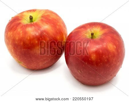 Two whole red Kanzi apples isolated on white background