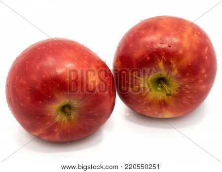 Two whole red Kanzi apples isolated on white background