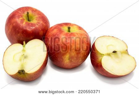 Red Kanzi apples, two whole, two halves, isolated on white background
