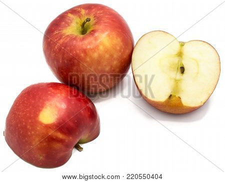 One whole red Kanzi apple, two halves, isolated on white background