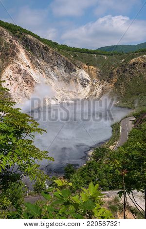 The hot water of Oyunuma pond in the volcanic landscape of Hell Valley (Jigokudani), Noboribetsu, Hokkaido, Japan