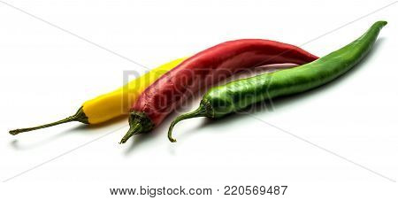 Red, green and yellow Cayenne Chili peppers isolated on white background whole