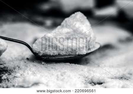 Common Salt,sodium Chloride In A Wooden Scoop On Wooden Floor.