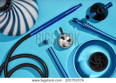 Top view of Hookah parts on light blue background. Still life. Copy space. Flat lay