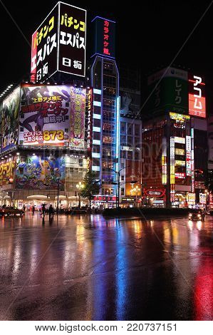 Tokyo, Japan - May 9, 2012: People Shop In The Rain In Shinjuku District, Tokyo. Shinjuku Is One Of 