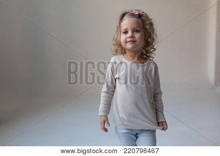A nice little girl in a gray blank sweatshirt. Mock up.