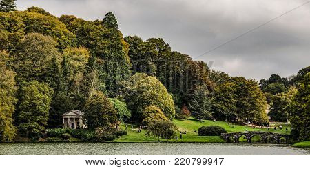 Panoramic view on English public park during autumn time.