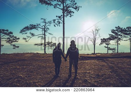 Photographer lover women and men asians travel relax in the holiday. Photograph sunrise in the morning among people. In the winter. In Thailand