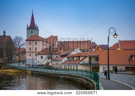 Small town Blatna on embankment of river Lomnice in evening time, Czech Republic