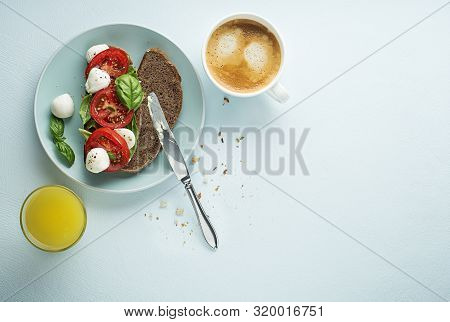 Delicious Healthy Breakfast With Tomato And Mozzarella Sandwich, Coffee And Juice. Concept For Healt