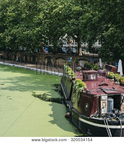 London, Uk - July 18, 2019: View Of Waterside Boat Cafe Moored On Regents Canal In Little Venice, Lo
