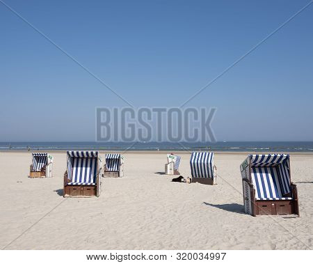 Beach Korbs On The Island Of Norderney In Germany Off The Coast Of East Frieland On Sunny Day In Aug
