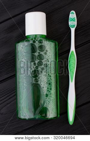 Toothbrush And Rinser For Teeth. Mouthwash Plastic Bottle. Concept Of Oral Hygiene.