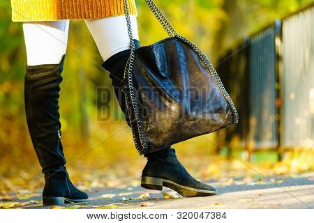 Woman Presenting Black Suede High Knee Black Boots Holding Big Hand Bag. Autumnal Fashion, Autumn Se