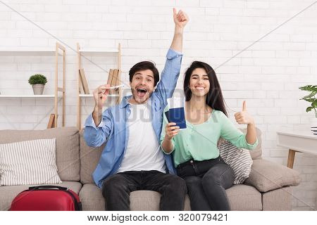 Ready For Vacation. Happy Couple Showing Passports And Thumbs Up, Looking At Camera