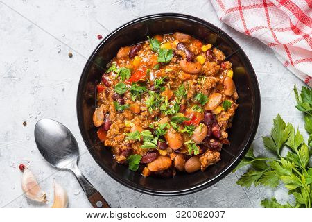 Chili Con Carne From Meat, Beans And Vegetables In Black Plate On Stone Table. Traditional Mexican F