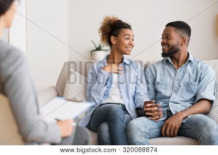 Marriage Reconciliation. Happy Black Spouses Sharing Good News With Marital Counselor. Selective Foc
