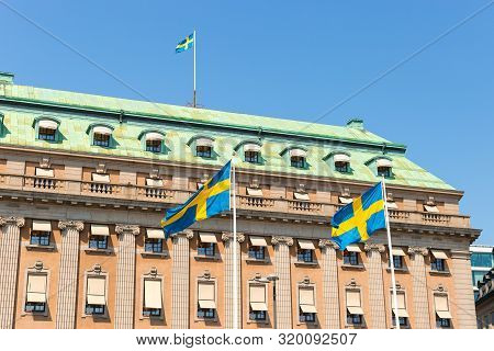 Flags Of Of Sweden On Gustav Adolfs Torg And Blue Sky Background