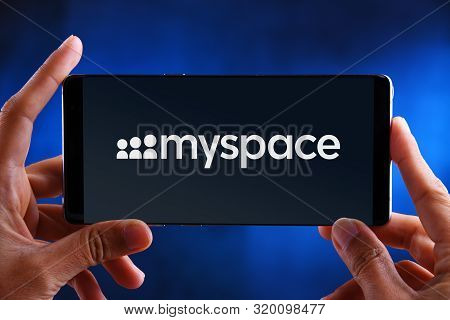Poznan, Pol - Jul 10, 2019: Hands Holding Smartphone Displaying Logo Of Myspace, A Social Networking
